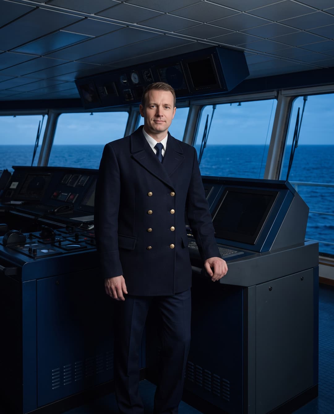 Uniformed captain on watch on the bridge